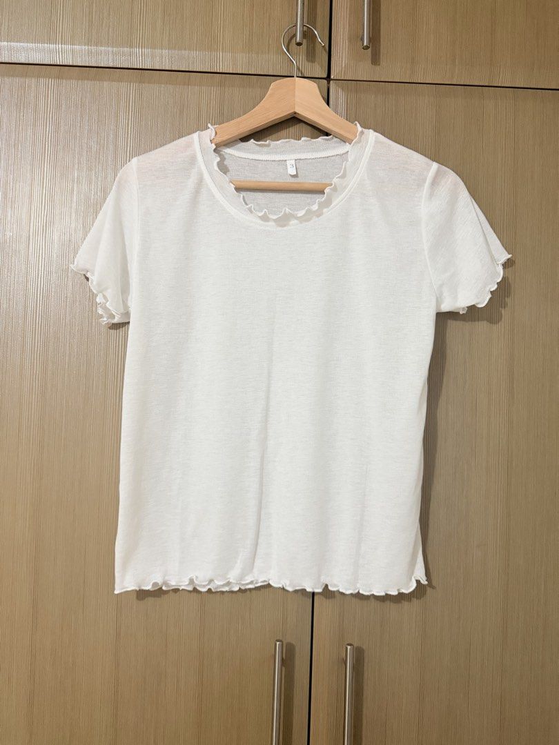 White Lettuce Trim Short Sleeve Tee (Category: Shirts) located in Manila. Submitted by mengxir20193848 (Listing ID 1464704273, Image 1). Description: - Color: Plain white - Style: Casual everyday basic short-sleeve top - Details: Cute lettuce edge trim along the neckline, cuffs, and hem - Material: Lightweight and slightly sheer - Neckline: Classic crew neck - Size: Tag reads size 3 never used.