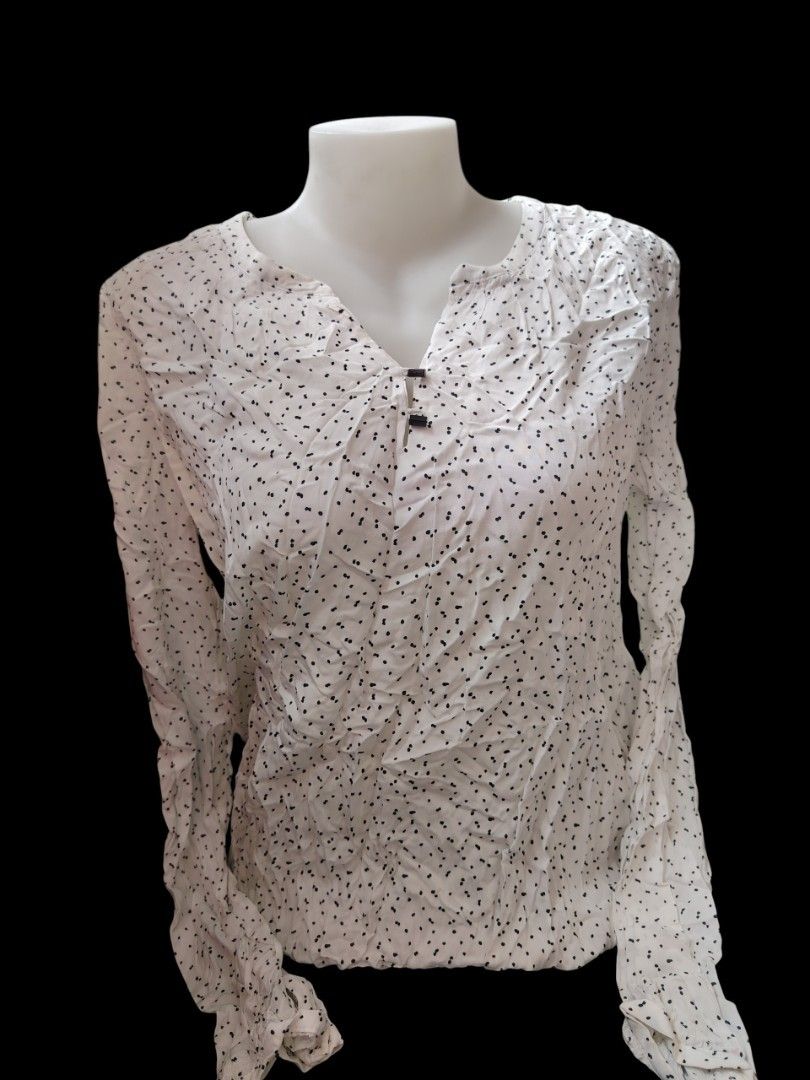 White Polka Dot Long Sleeve Blouse with Button Detail (Category: Longsleeves) located in Antipolo. Submitted by goodsinger (Listing ID 1464607659, Image 1). Description: - White long sleeve blouse - Black polka dot pattern - V-neckline with two small black button details - Slightly gathered cuffs - Crinkled fabric texture - Versatile for casual or dressed-up looks.