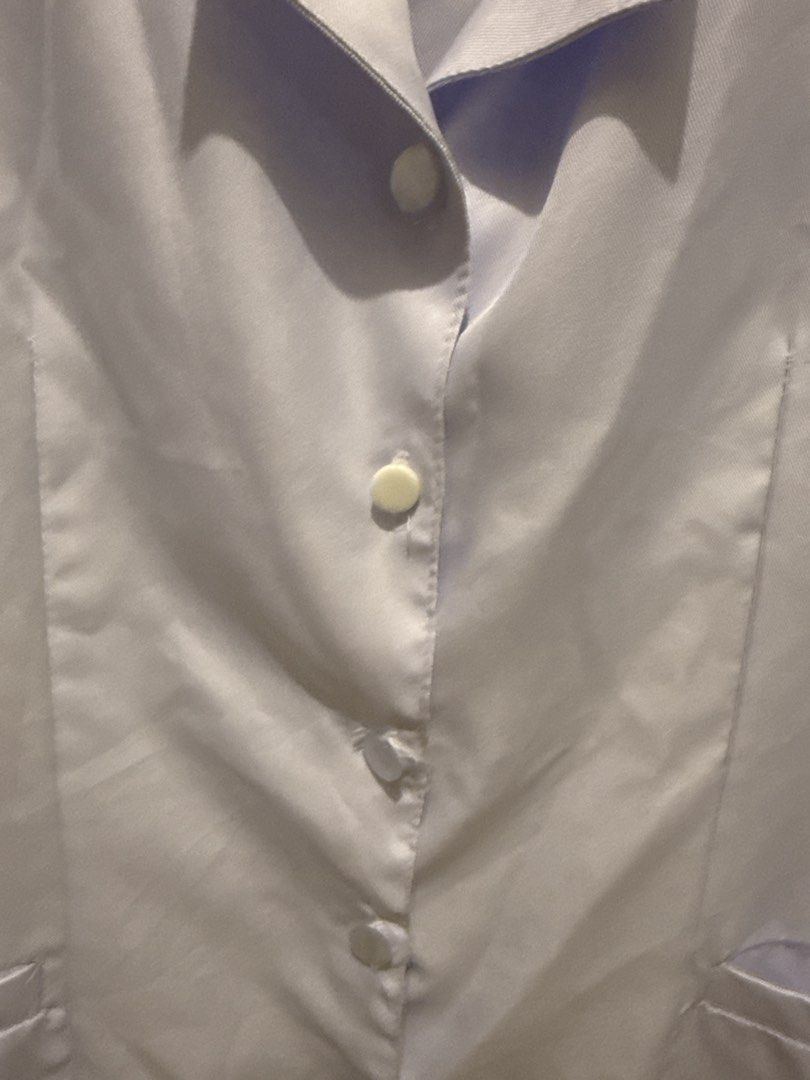 White polo/nursing blouse TOP ONLY (Category: Blouses) located in Quezon City. Submitted by joroguhi (Listing ID 1464735846, Image 3). Description: Large on tag With one button replaced with a different color ng button (wala po akong clear 😅) Clean and ready to use. NALABHAN NA PO. Planchahin niyo nalang po 📍qc, near vertis north.