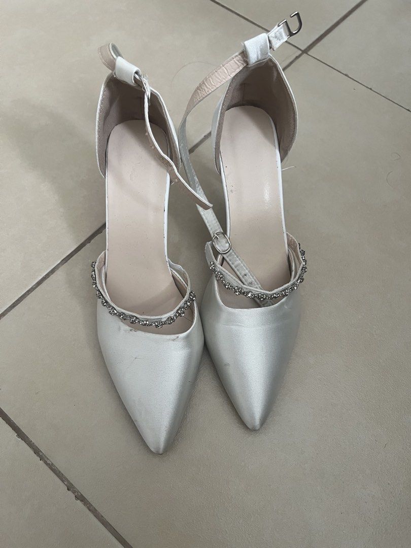 White Satin Heels with Ankle Strap and Rhinestone (Category: Heels) located in Manila. Submitted by doonav (Listing ID 1464597399, Image 1). Description: - size 38 - 3.3 inches - bought for 341 - White satin heels - Pointed toe - Ankle strap with buckle closure - Delicate rhinestone detailing - Ideal for weddings and special occasions - Used for graduation - Has minor flaws and needs cleaning.