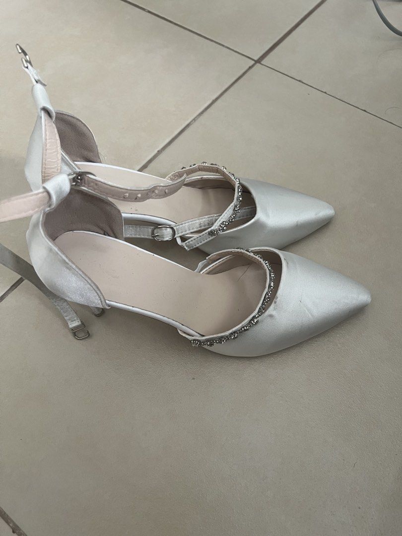White Satin Heels with Ankle Strap and Rhinestone (Category: Heels) located in Manila. Submitted by doonav (Listing ID 1464597399, Image 2). Description: - size 38 - 3.3 inches - bought for 341 - White satin heels - Pointed toe - Ankle strap with buckle closure - Delicate rhinestone detailing - Ideal for weddings and special occasions - Used for graduation - Has minor flaws and needs cleaning.