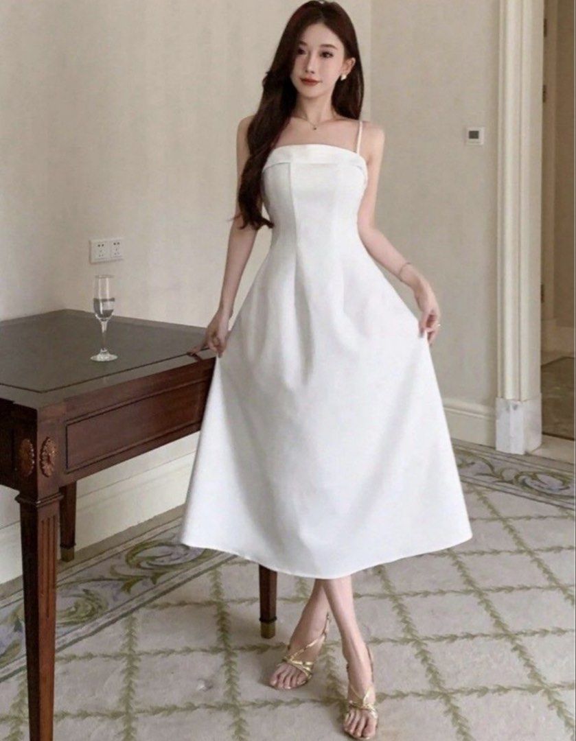 White Spaghetti Strap Midi Dress (Category: Dresses) located in Manila. Submitted by neachellbi45044 (Listing ID 1464689096, Image 1). Description: - Color: White - Length: Midi with flare skirt - Neckline: Straight neckline with thin straps - Design: Structured bodice paneling and back zipper with upper back V-cut - Condition: Worn a few times, cleaned, and ready to wear - With slight alterations but can be removed.