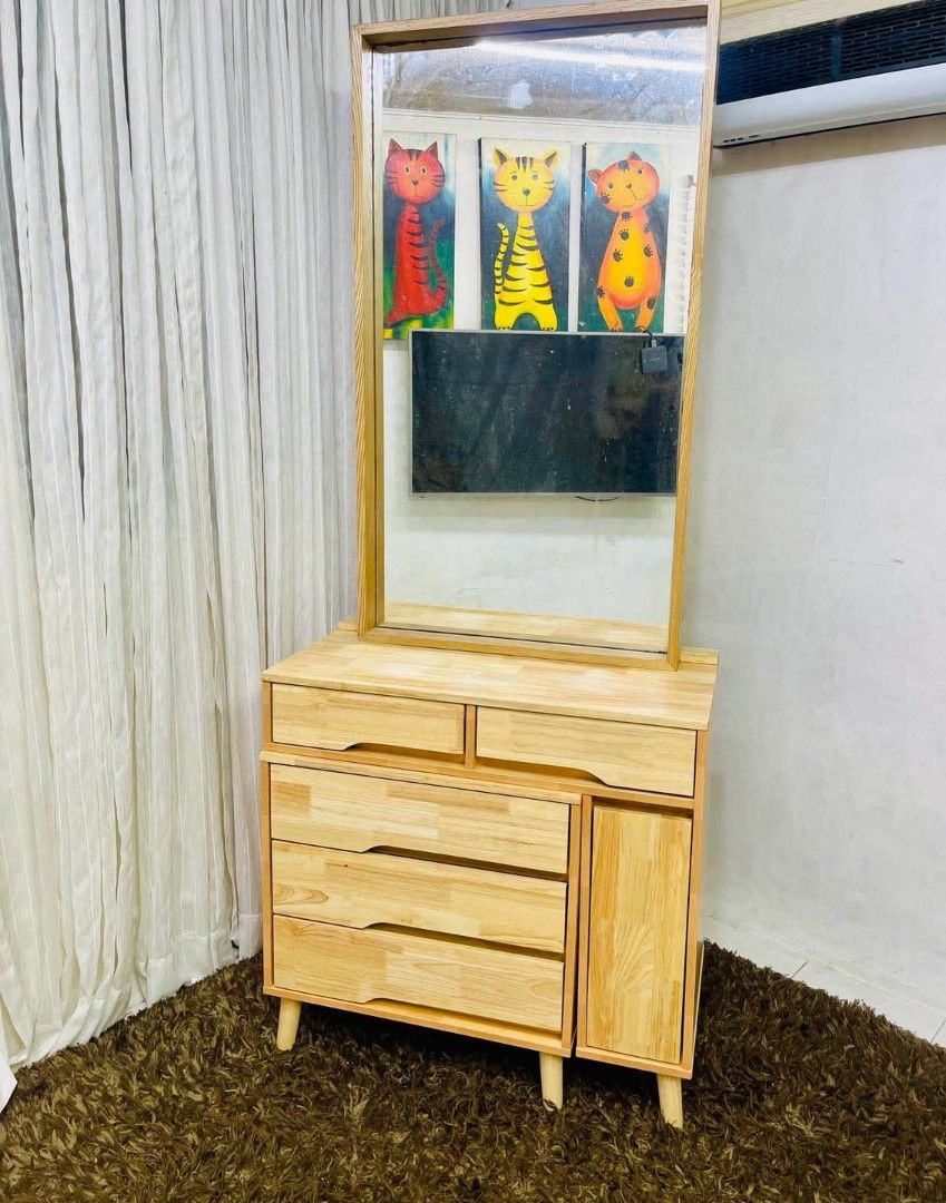 Wooden Dressing Table with Mirror and Storage (Category: Tables & Sets) located in Antipolo. Submitted by roselle001 (Listing ID 1464646642, Image 2). Description: - Solid wood construction for durability - Large, clear mirror for your reflection - Ample storage with multiple drawers and a cabinet - Beautiful, natural wood grain - Sturdy legs for stability - Perfect for organizing makeup and accessories.