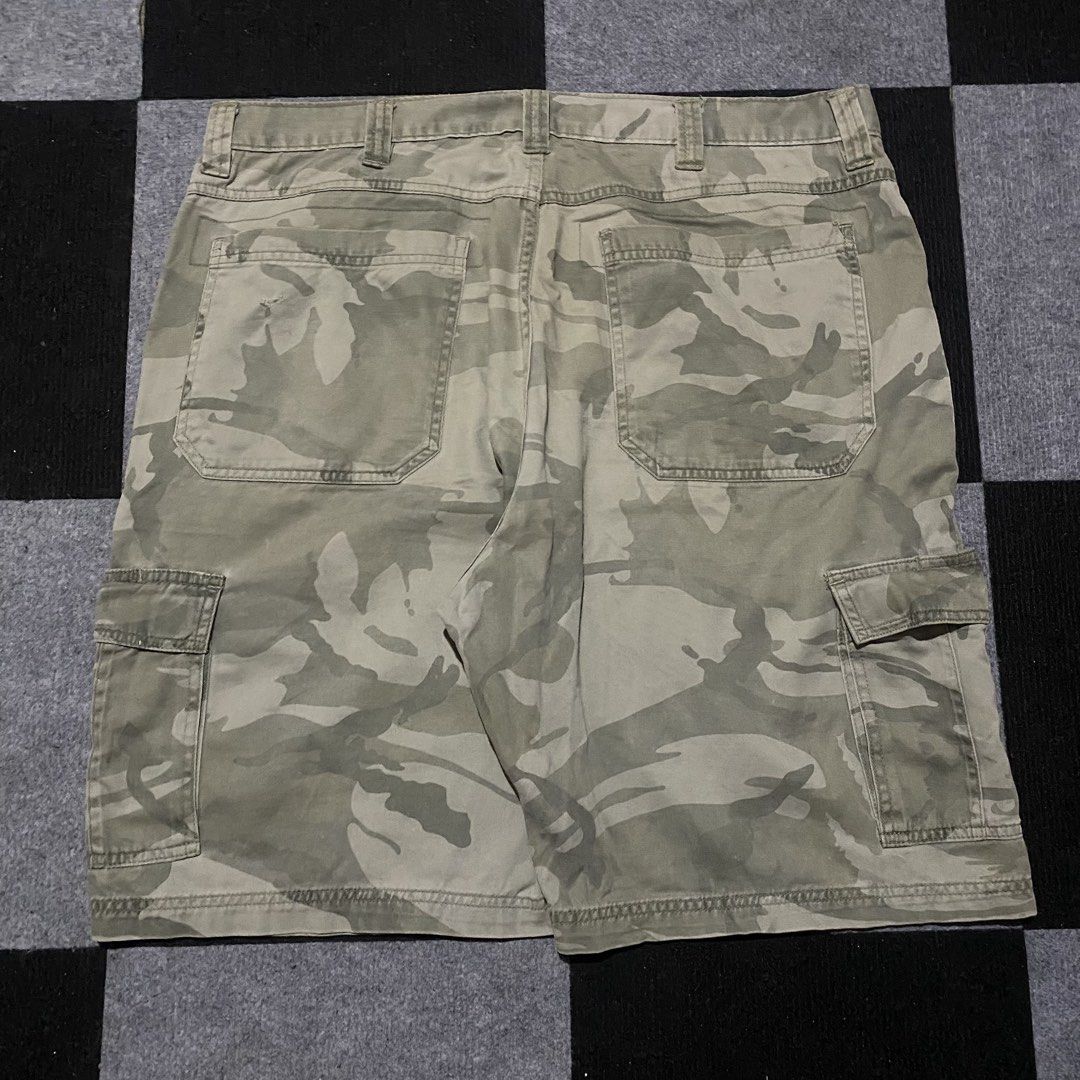 Wrangler Camouflage Cargo Shorts (Category: Shorts) located in Manila. Submitted by gregmarc5503863 (Listing ID 1464752267, Image 2). Description: - Brand: Wrangler - Design: Camouflage in green and tan tones - Material: Durable, high-quality cotton fabric - Pockets: Multiple utility pockets including button-flap cargo and back pockets - Closure: Branded metal button waist closure - Features: Standard belt loops - Style: Casual, great for outdoor