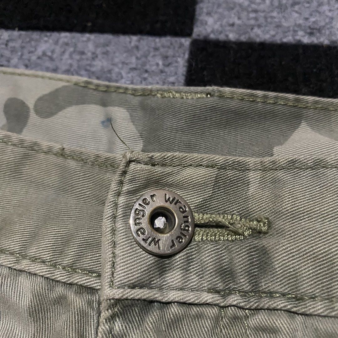 Wrangler Camouflage Cargo Shorts (Category: Shorts) located in Manila. Submitted by gregmarc5503863 (Listing ID 1464752267, Image 3). Description: - Brand: Wrangler - Design: Camouflage in green and tan tones - Material: Durable, high-quality cotton fabric - Pockets: Multiple utility pockets including button-flap cargo and back pockets - Closure: Branded metal button waist closure - Features: Standard belt loops - Style: Casual, great for outdoor