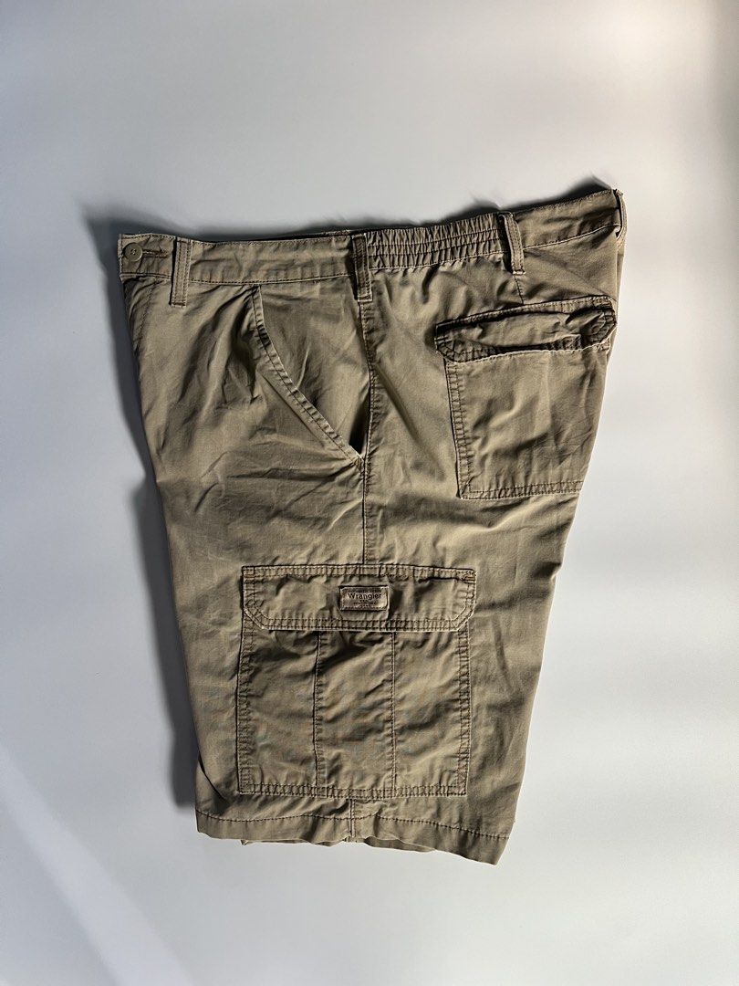 Wrangler Cargo Shorts Khaki (Category: Shorts) located in Baler. Submitted by allthrifted31 (Listing ID 1464732470, Image 3). Description: - Brand: Wrangler - Color: Khaki - Material: 100% Cotton, standard fit - Features: Multiple front, side, and back cargo pockets - Waist: Button closure with belt loops and comfort elastic side panels - Details: Signature woven Wrangler patch on the left pocket - Condition: Excellent, ready to wear.