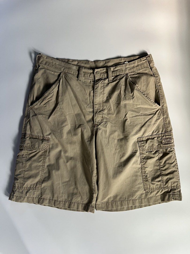 Wrangler Cargo Shorts Khaki (Category: Shorts) located in Baler. Submitted by allthrifted31 (Listing ID 1464732470, Image 1). Description: - Brand: Wrangler - Color: Khaki - Material: 100% Cotton, standard fit - Features: Multiple front, side, and back cargo pockets - Waist: Button closure with belt loops and comfort elastic side panels - Details: Signature woven Wrangler patch on the left pocket - Condition: Excellent, ready to wear.