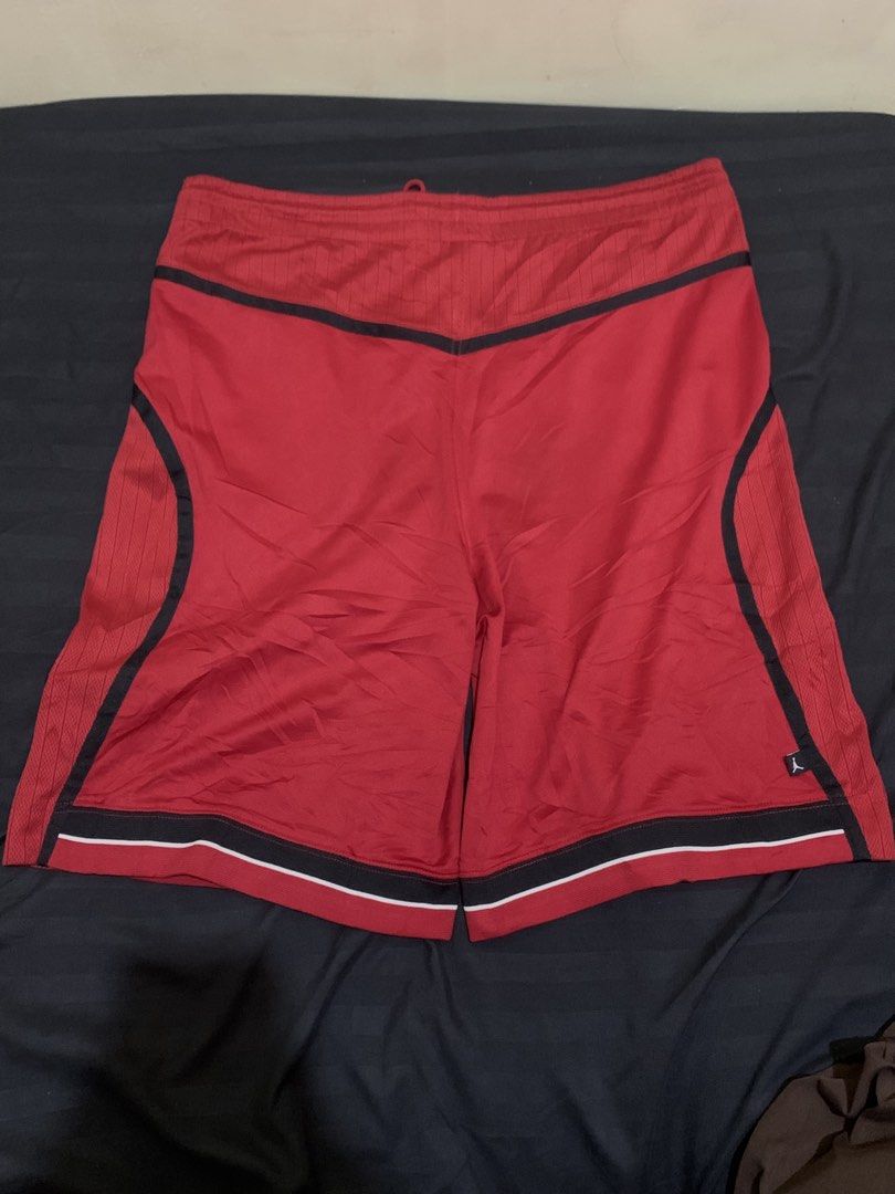 Y2k Jordan (Category: Shorts) located in Roxas City. Submitted by vaultcultureco. (Listing ID 1464676724, Image 2). Description: - Y2k Jordan basketball shorts - Vibrant red color with black trim - Features mesh side panels for breathability - Iconic Jumpman logo on the left leg - Circular Jordan logo on the right leg - Adjustable drawstring waist for a custom fit - Size XL - Perfect for basketball or casual wear.