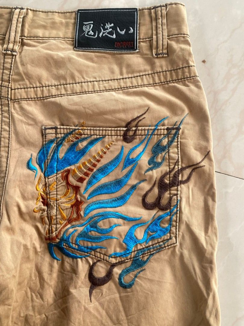 Y2k Oniarai (Category: Shorts) located in Santo Tomas. Submitted by liyothrift (Listing ID 1464703427, Image 3). Description: Y2k Oniarai japan khaki-colored cargo shorts featuring a distinctive blue and gold flame or oni mask embroidery. Waist: 32 Length: 22 Leg opening: 9 Color: 10/10 Excellent to as new free ship No issue 📩📩📩.