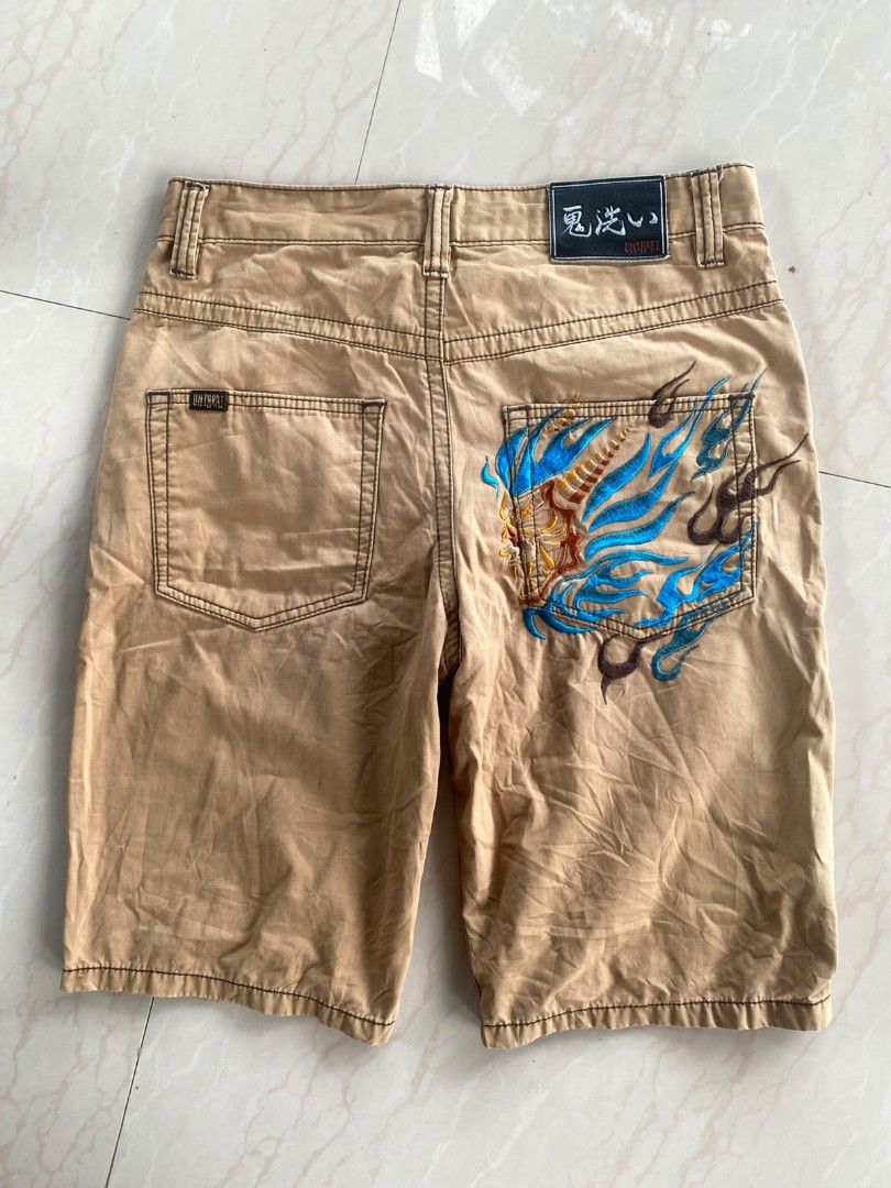 Y2k Oniarai (Category: Shorts) located in Santo Tomas. Submitted by liyothrift (Listing ID 1464703427, Image 2). Description: Y2k Oniarai japan khaki-colored cargo shorts featuring a distinctive blue and gold flame or oni mask embroidery. Waist: 32 Length: 22 Leg opening: 9 Color: 10/10 Excellent to as new free ship No issue 📩📩📩.