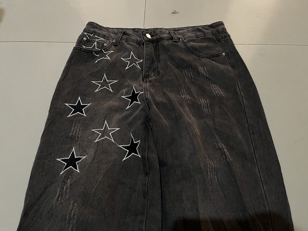 Y2K Star Embroidered Distressed Denim Pants (Category: Jeans) located in Baguio. Submitted by nifty.grails (Listing ID 1464571805, Image 2). Description: W: 31 L: 42 Acid/Washed Black Denim Embroidered star patterns Minor Distressing Texture Zippered Side Hems.