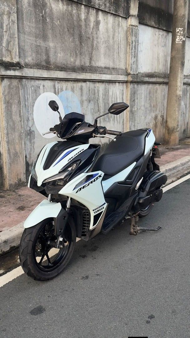 Yamaha Aerox 155cc Scooter (Category: Motorbikes for Sale) located in Marikina City. Submitted by traviz_ (Listing ID 1464597176, Image 1). Description: Selling my Yamaha Aerox 155. White and black colorway with blue accents. Great for city commuting. Well-maintained and runs smoothly. Ready for its next owner. Message me for viewing..