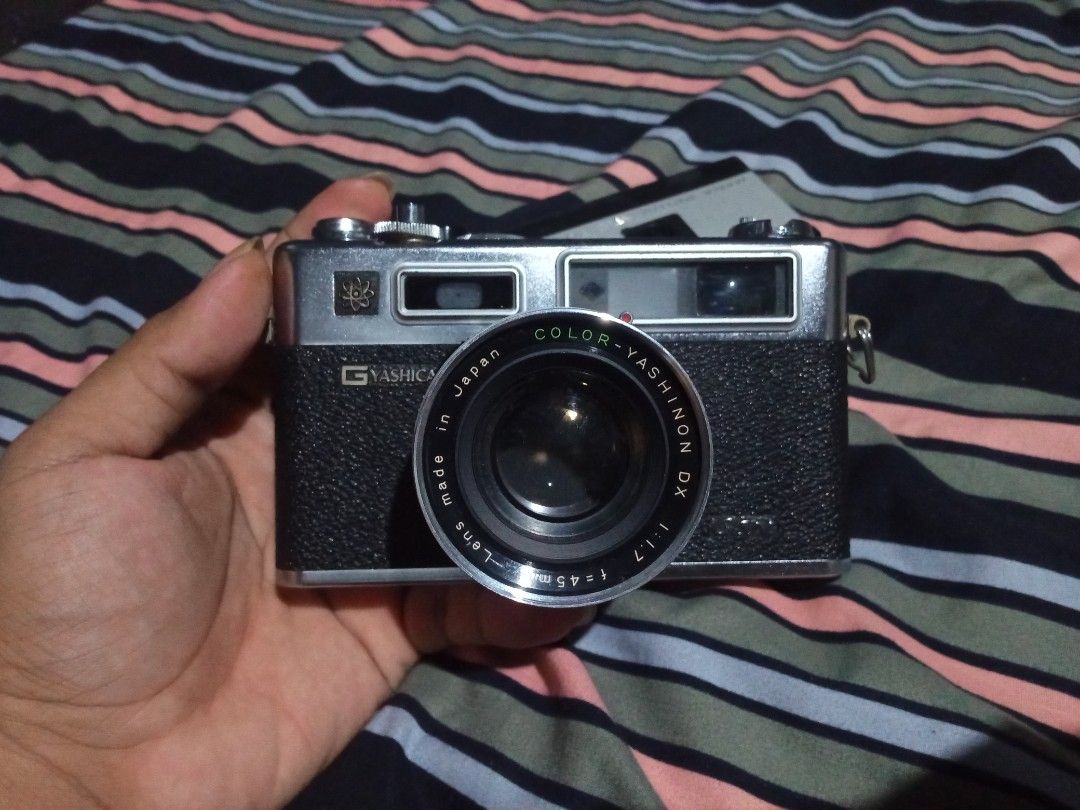 Yashica Electro 35 GSN (send offers) (Category: Cameras) located in Minglanilla. Submitted by keith_digicams (Listing ID 1464708390, Image 3). Description: - Camera: Yashica Electro 35 vintage analog rangefinder - Lens: Color-Yashinon DX 45mm f/1.7 - Shutter: Copal leaf shutter - Features: Battery check button with red indicator light, top plate ASA film speed dial, and hot shoe - Condition: Clean film chamber with intact pressure plate - Build: 