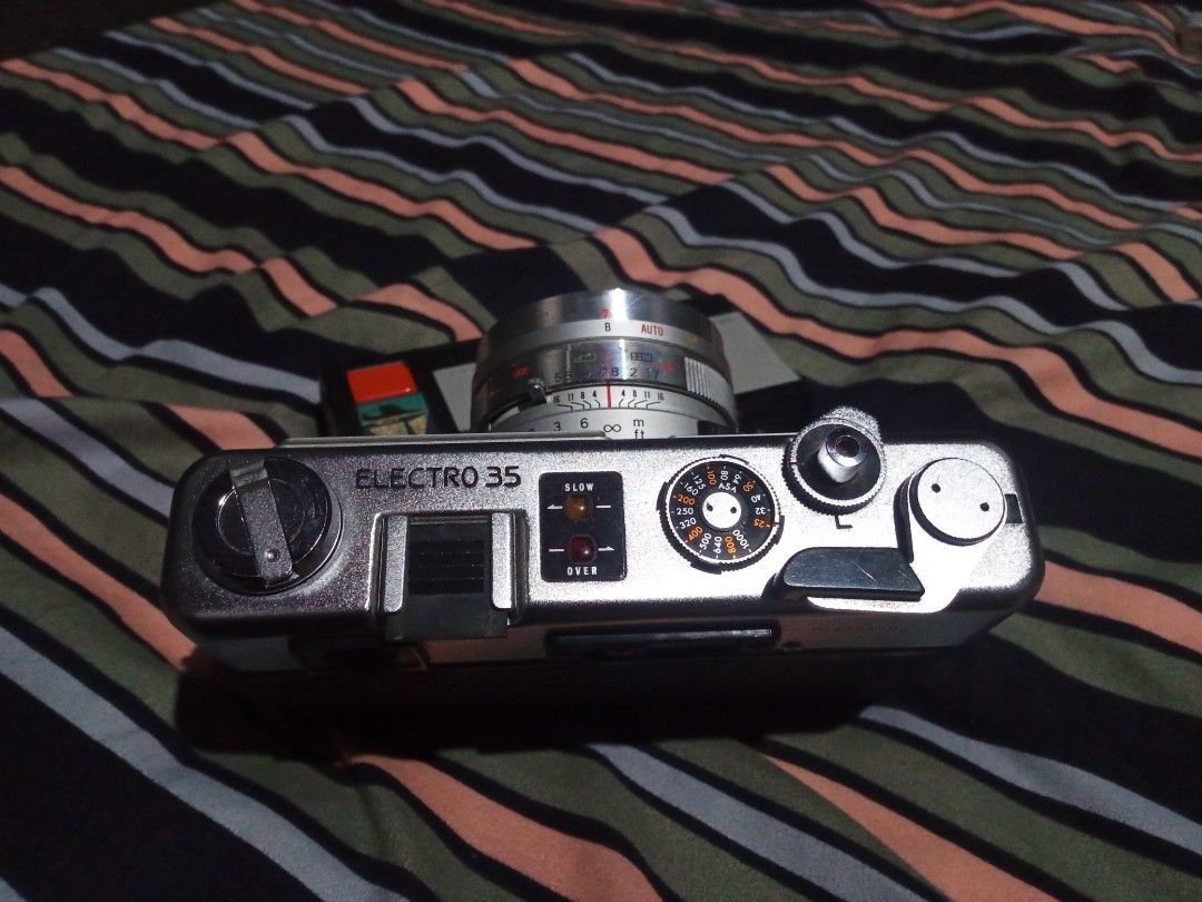 Yashica Electro 35 GSN (send offers) (Category: Cameras) located in Minglanilla. Submitted by keith_digicams (Listing ID 1464708390, Image 2). Description: - Camera: Yashica Electro 35 vintage analog rangefinder - Lens: Color-Yashinon DX 45mm f/1.7 - Shutter: Copal leaf shutter - Features: Battery check button with red indicator light, top plate ASA film speed dial, and hot shoe - Condition: Clean film chamber with intact pressure plate - Build: 