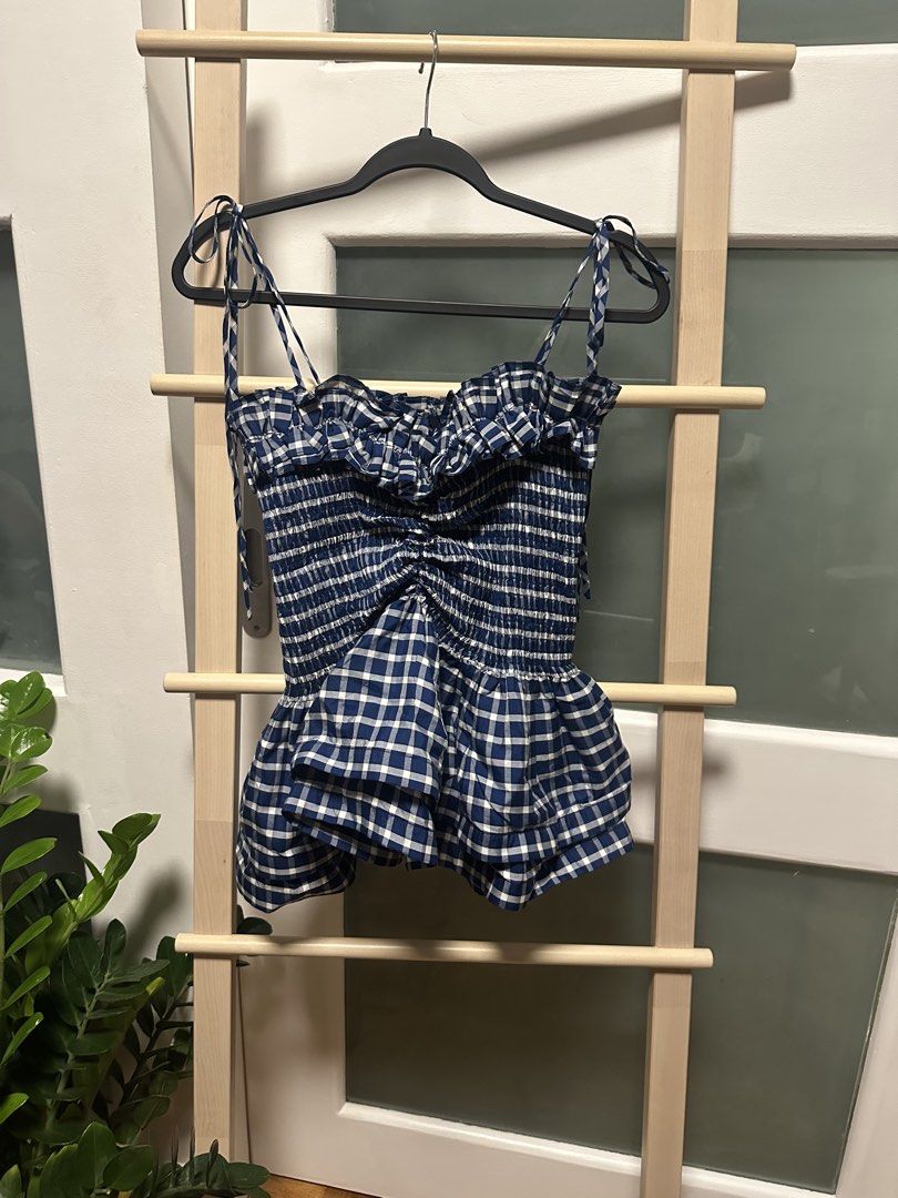 YONG STUDIO Namibia top in Blue Gingham -30% off (Category: Sleeveless) located in Santa Rosa. Submitted by ms.addtocart (Listing ID 1464745234, Image 1). Description: - Brand: Yong Studio (signature best selling design) - Condition: Brand new with tags - Color: Mustard yellow - Design: Smocked bodice with ruffled sweetheart neckline, signature textured structured layered peplum hem - Straps: Adjustable tie straps - Size: XL but fits Small-Medium