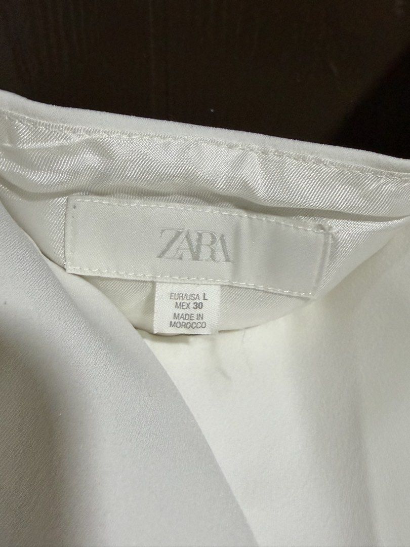 ZARA Asymmetrical Skirt (Category: Skirts) located in Quezon City. Submitted by hey.cider (Listing ID 1464582519, Image 3). Description: ZARA ASYMMETRIC RUFFLED SKIRT Mid-waist skirt with matching fabric ruffles. Asymmetric hem. Concealed in-seam zip fastening. Color: White Size: Large (40.9” or 104cm) Condition: Brand New RFS: decluttering MOP: maya/gcash/qr Shipping: lalamove/lbc.