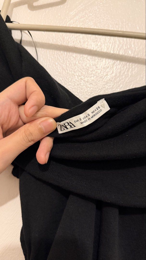 Zara Black Off-Shoulder Lettuce Hem Top (Category: Blouses) located in Tarlac. Submitted by mariebiscuitttttt (Listing ID 1464640889, Image 2). Description: - Used once - Brand: Zara - Color: Black - Style: Off-shoulder top - Material: Ribbed - Features: Lettuce hem, can be worn on or off the shoulder - Versatility: Perfect for dressing up or down - Size: Fits true to size S 📍Tarlac City, Tarlac.