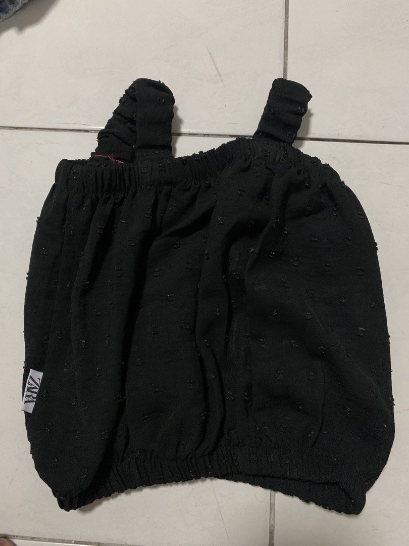 Zara Black Sleeveless Textured Top (Category: Babies & Kids Fashion) located in Malabon City. Submitted by vewonica (Listing ID 1464699572, Image 1). Description: - Brand: Zara - Style: Black sleeveless top with thick ruffled straps - Material: Lightweight textured fabric with tiny raised dots - Fit: Elastic band along neckline and bottom hem for a gathered look - Versatility: Easy to match with jeans or skirts.