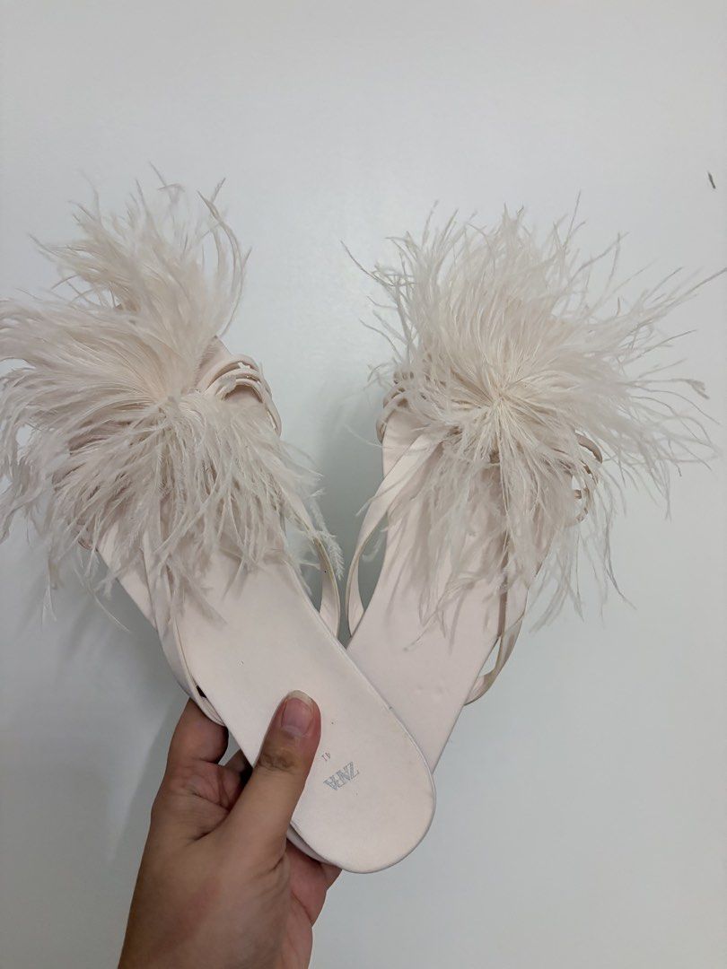 Zara Feather Sandals Pink Size 41 (Category: Flats & Sandals) located in Manila. Submitted by cheska.closet18 (Listing ID 1464734420, Image 1). Description: - Brand: Zara - Style: Feather sandals / slip-on flats - Color: Pale pink - Size: 41 - Details: Soft flat sole, strap design, and a big fluffy feather pom-pom - Inclusions: Original Zara dust bag (note: faint marks on the fabric) - Perfect for: Parties, dinners, or elevating a simple everyday