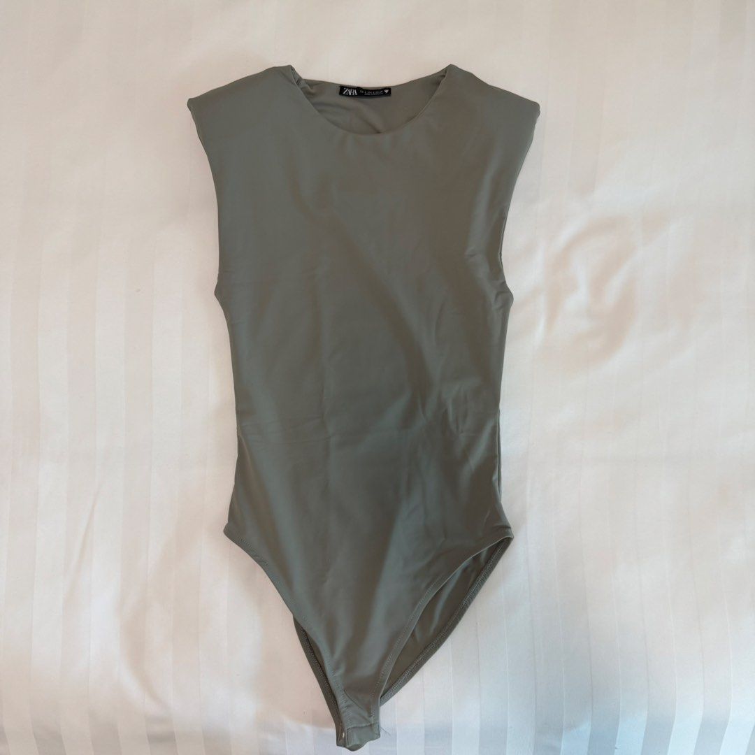 Zara Grey Padded Shoulder Bodysuit (Category: Sleeveless) located in Makati City. Submitted by agl.ph (Listing ID 1464584951, Image 1). Description: Never used Padded shoulder bodysuit.