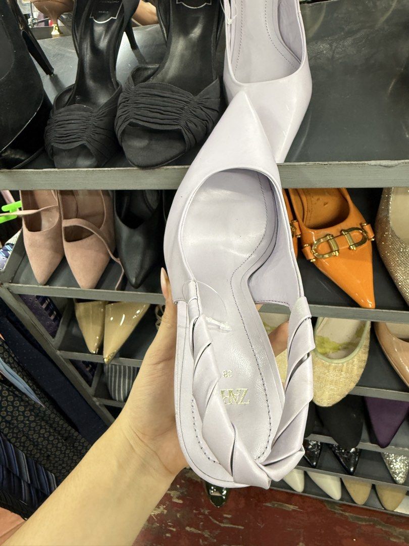 Zara Lilac Pointed Toe Slingback Heels Size 38 (Category: Heels) located in Manila. Submitted by fastlion.584bdf (Listing ID 1464737934, Image 2). Description: - Brand: Zara - Style: Lilac slingback heels with pointy toes and twisted back strap - Heel: High block heel - Size: 38 (stamped on sole) - Flaws: Scuff mark near the front toe area; bottom heel tip missing on one shoe (inner core exposed) - Condition: Sold as-is.