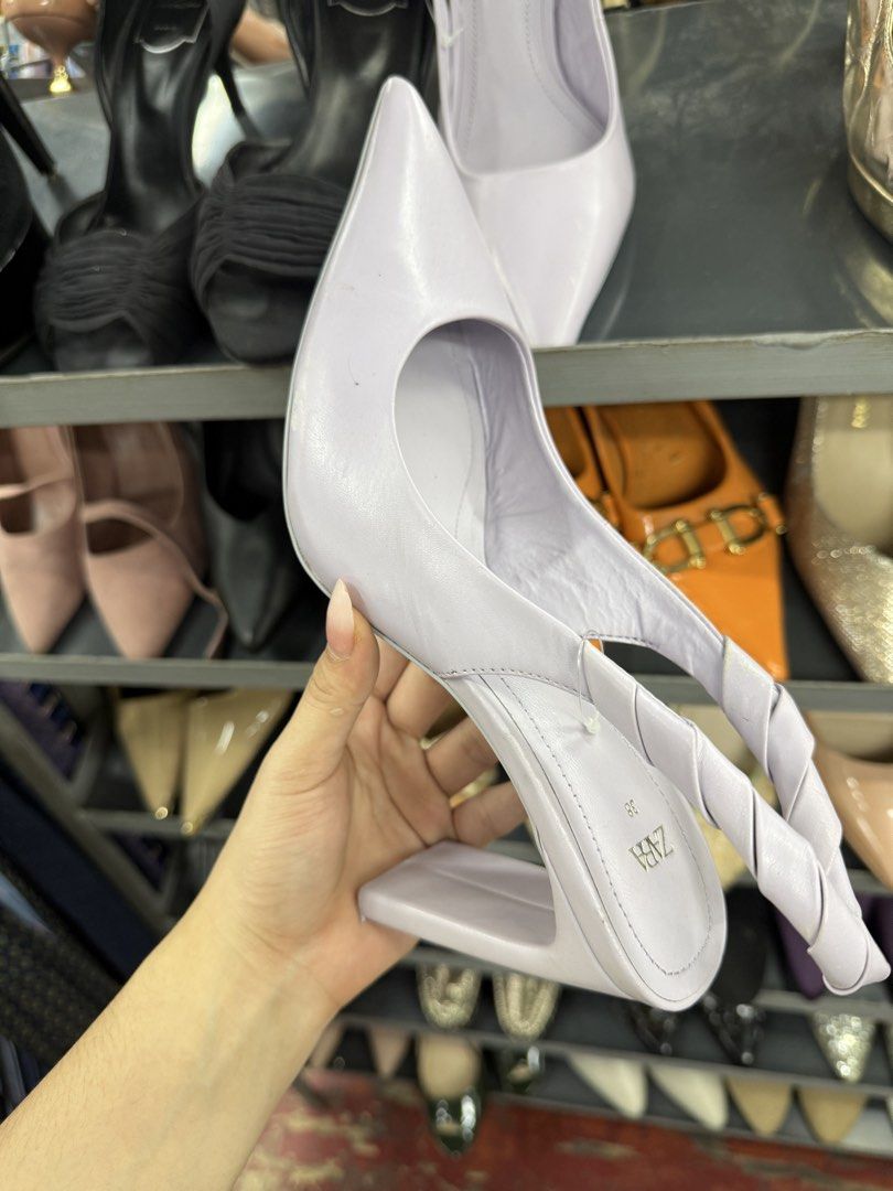 Zara Lilac Pointed Toe Slingback Heels Size 38 (Category: Heels) located in Manila. Submitted by fastlion.584bdf (Listing ID 1464737934, Image 1). Description: - Brand: Zara - Style: Lilac slingback heels with pointy toes and twisted back strap - Heel: High block heel - Size: 38 (stamped on sole) - Flaws: Scuff mark near the front toe area; bottom heel tip missing on one shoe (inner core exposed) - Condition: Sold as-is.