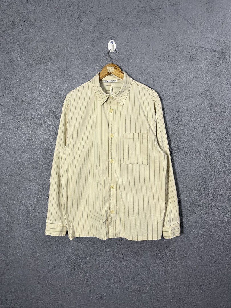 Zara Striped Long Sleeve Button-Up Shirt (Category: Longsleeves) located in Famy. Submitted by basicthrifted (Listing ID 1464702011, Image 1). Description: - Brand: Zara - Style: Striped button-up shirt with chest pocket and classic collar - Color: Beige with dark vertical lines - Size: Medium (Regular Fit) - Origin: Made in Turkey - Condition: Clean piece overall, great for casual or smart-casual wear.