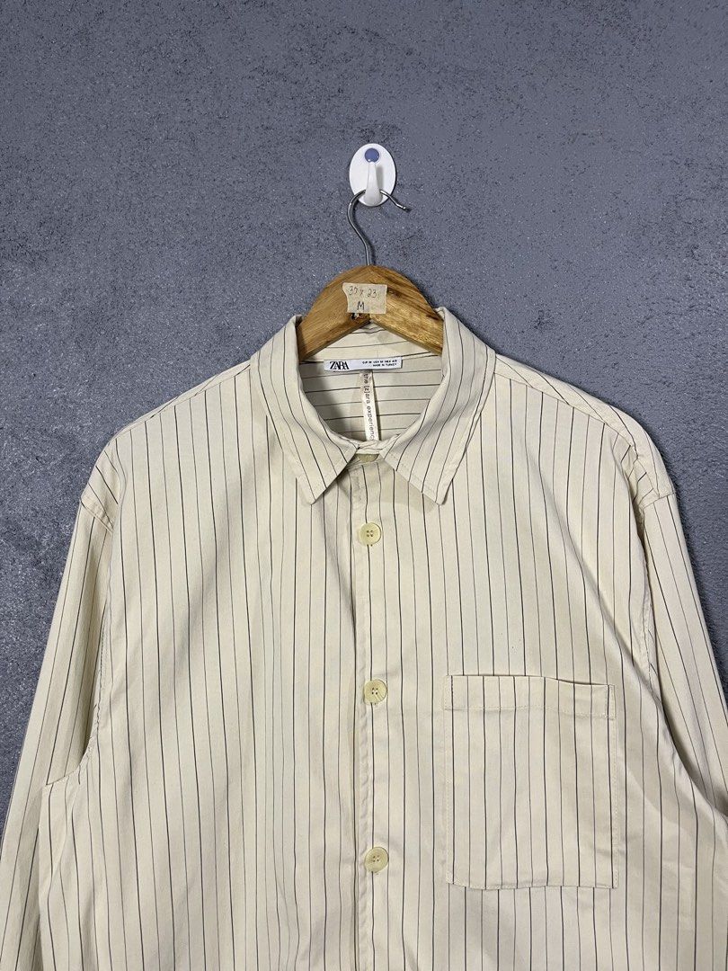 Zara Striped Long Sleeve Button-Up Shirt (Category: Longsleeves) located in Famy. Submitted by basicthrifted (Listing ID 1464702011, Image 2). Description: - Brand: Zara - Style: Striped button-up shirt with chest pocket and classic collar - Color: Beige with dark vertical lines - Size: Medium (Regular Fit) - Origin: Made in Turkey - Condition: Clean piece overall, great for casual or smart-casual wear.