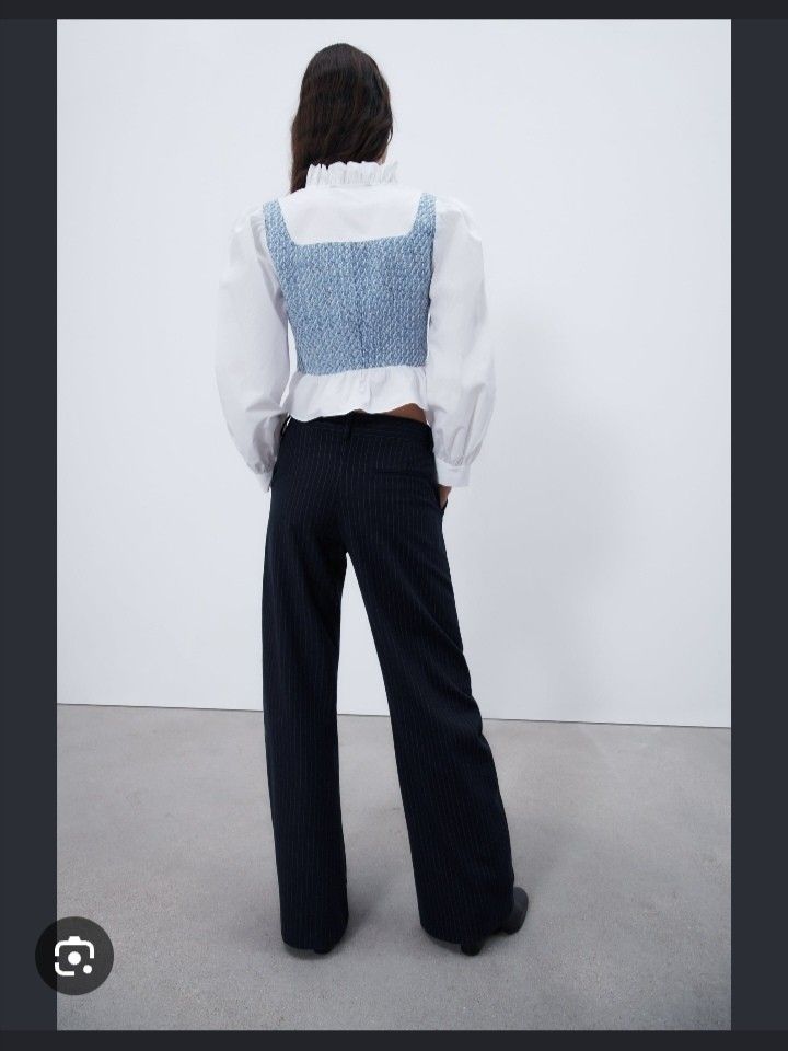 Zara tweed top (Category: Blouses) located in Makati City. Submitted by lilsuzies (Listing ID 1464698193, Image 2). Description: - Brand: Zara - Size: M zipper on the side - Design: White long sleeves with a blue smocked bodice overlay - Details: Ruffle collar, ruffle cuffs, and front neck tie closure - Silhouette: Cropped with a trendy flared hem - Fun Fact: Worn on TV by an It's Showtime host! - Condition: Excellent, ready to wear.