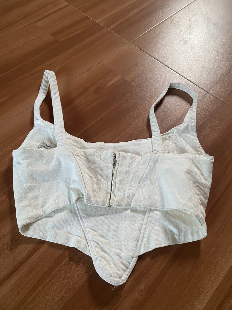 ZARA White Denim Corset Top (Category: Sleeveless) located in Manila. Submitted by reginemarquez412 (Listing ID 1464673662, Image 1). Description: - Zara white denim corset top - Size: Medium (M) - Features a zip-up front - Structured bodice - Adjustable straps - Versatile styling: pairs well with high-waisted jeans or skirts.