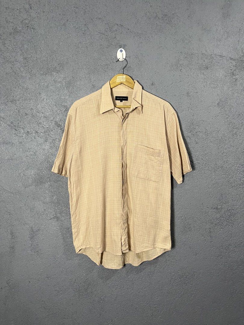 Zero Est Hour Checked Short Sleeve Shirt Size L (Category: Tshirts & Polo Shirts ) located in Famy. Submitted by basicthrifted (Listing ID 1464703813, Image 1). Description: - Brand/Model: Zero Est Hour short sleeve button-down shirt - Color/Pattern: Beige and white plaid check - Size: L (tagged on black neck label) - Measurements (laid flat): 28" length, 23" pit to pit - Features: Classic collar, single chest pocket, lightweight textured fabric 