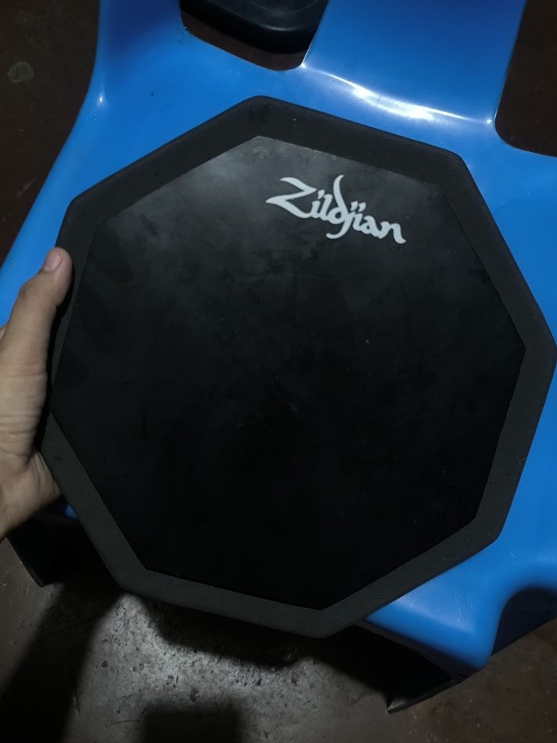 Zildjian Practice Pad Drum Pad (Category: Musical Instruments) located in Muntinlupa City. Submitted by narymadine_ (Listing ID 1464705435, Image 2). Description: - Authentic Zildjian practice pad with octagonal design - Durable rubber playing surface for a realistic rebound - Non-slip foam backing keeps the pad secure during sessions - Excellent tool for building stick control and rudiments quietly at home - Condition: Shows normal signs of use,