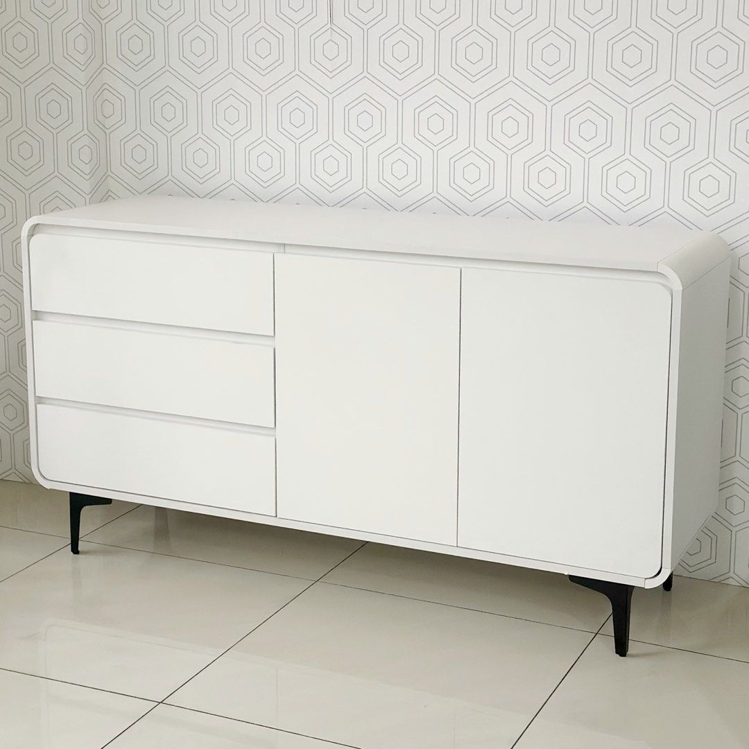 140cm Tv Rack Console Cabinet (Category: Shelves, Cabinets & Racks) located in Marikina City. Submitted by lovegoeson (Listing ID 1464890388, Image 1). Description: - Dimensions: 140cm length x 100cm height - Color: Clean minimalist white finish with black legs - Storage: 3 smooth pull-out drawers and a spacious 2-door cabinet with interior shelving - Condition: like new, ready stock (not pre-order) - Ideal as a TV media console, sideboard, or li