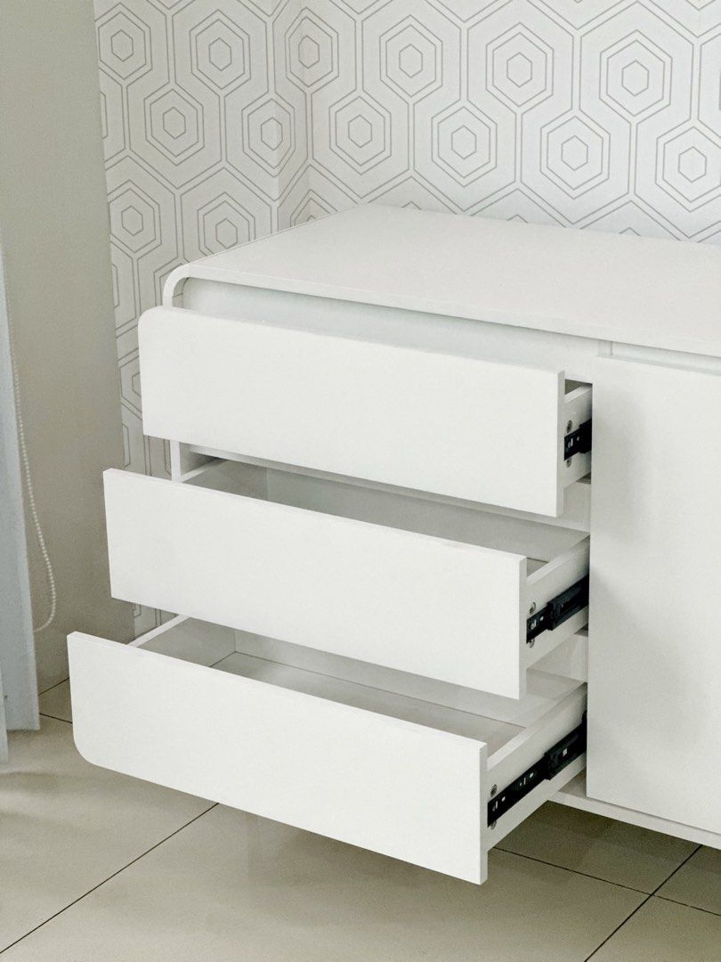 140cm Tv Rack Console Cabinet (Category: Shelves, Cabinets & Racks) located in Marikina City. Submitted by lovegoeson (Listing ID 1464890388, Image 3). Description: - Dimensions: 140cm length x 100cm height - Color: Clean minimalist white finish with black legs - Storage: 3 smooth pull-out drawers and a spacious 2-door cabinet with interior shelving - Condition: like new, ready stock (not pre-order) - Ideal as a TV media console, sideboard, or li