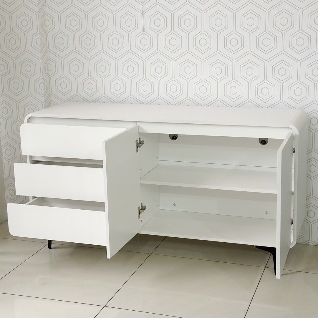 140cm Tv Rack Console Cabinet (Category: Shelves, Cabinets & Racks) located in Marikina City. Submitted by lovegoeson (Listing ID 1464890388, Image 2). Description: - Dimensions: 140cm length x 100cm height - Color: Clean minimalist white finish with black legs - Storage: 3 smooth pull-out drawers and a spacious 2-door cabinet with interior shelving - Condition: like new, ready stock (not pre-order) - Ideal as a TV media console, sideboard, or li