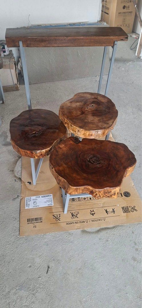3 pcs per set at Php 7200, Solid wood live edge table and three round stools set (Category: Tables & Sets) located in Pasig City. Submitted by casambhomedecors (Listing ID 1464964979, Image 3). Description: - Handcrafted live edge wood furniture set - Includes 1 rectangular high table and 3 matching round tree trunk slice stools - Sturdy grey metal legs on all pieces for maximum durability - Rich, polished natural wood grain finish highlighting u