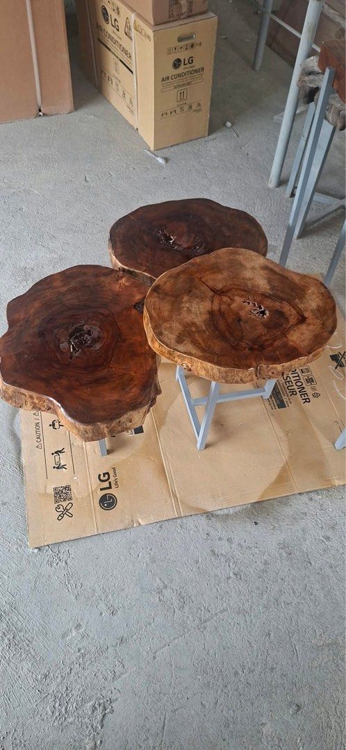 3 pcs per set at Php 7200, Solid wood live edge table and three round stools set (Category: Tables & Sets) located in Pasig City. Submitted by casambhomedecors (Listing ID 1464964979, Image 1). Description: - Handcrafted live edge wood furniture set - Includes 1 rectangular high table and 3 matching round tree trunk slice stools - Sturdy grey metal legs on all pieces for maximum durability - Rich, polished natural wood grain finish highlighting u