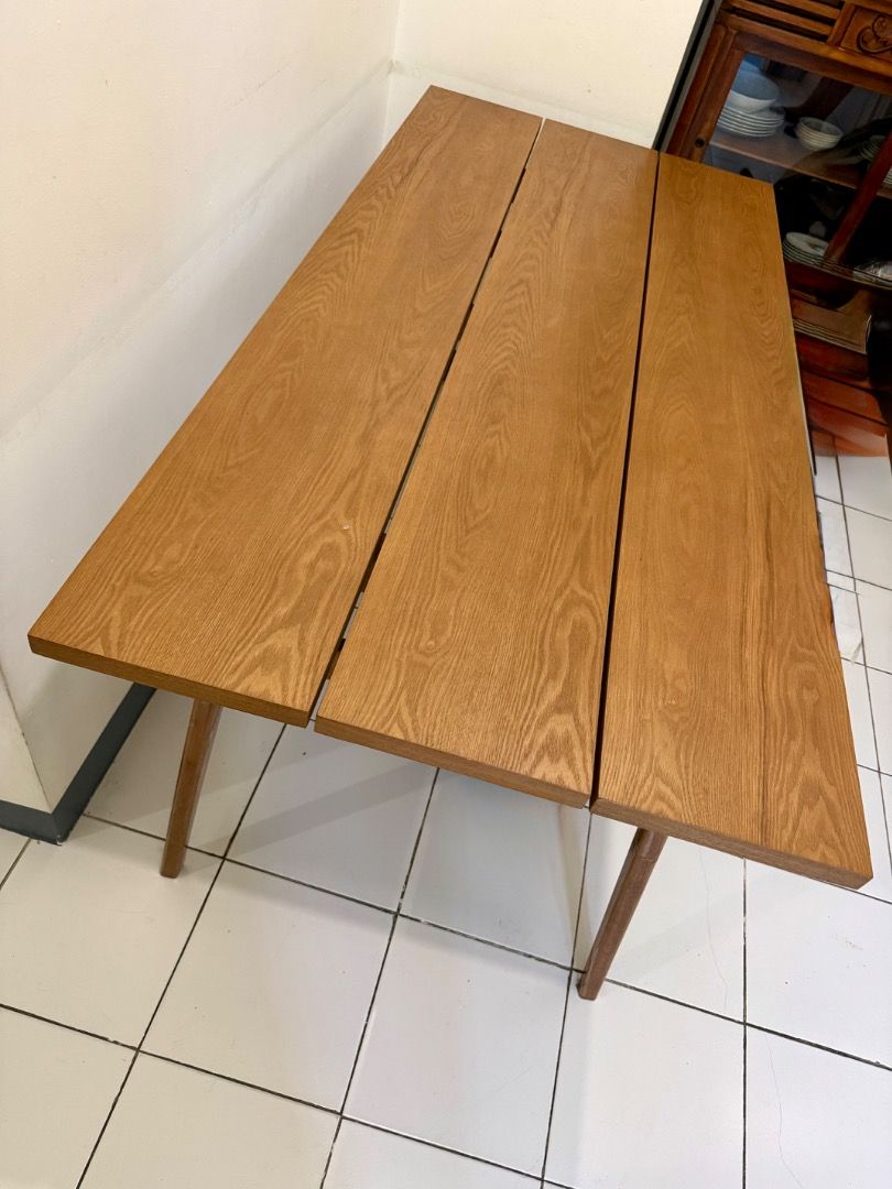 3-plank Wooden Dining Table (Category: Tables & Sets) located in Manila. Submitted by momobichon (Listing ID 1464806008, Image 2). Description: Beautiful 3-plank dining table with rich, natural oak grain and a warm honey finish. The slatted top gives it a modern farmhouse / Scandinavian look, and the angled, tapered legs add a clean mid-century touch. It seats 4 comfortably (6 in a pinch), and also works well as a work desk or a statement piece i