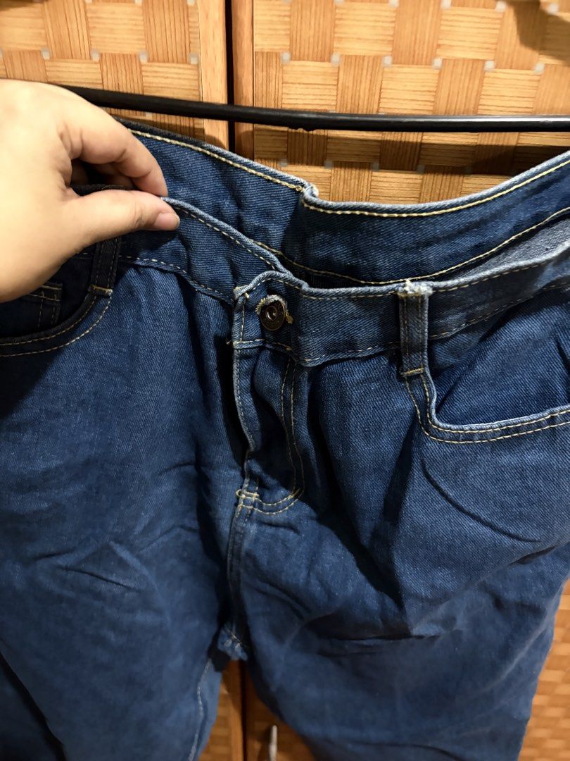 919 Jeans Blue Denim Pants (Category: Jeans) located in Pangil. Submitted by chel_anne (Listing ID 1464842654, Image 2). Description: - Brand/Model: 919 Jeans - Wash: Medium wash denim - Fit: Straight leg, versatile casual wear - Details: Classic five-pocket design with contrast stitching - Waistband: Button closure with belt loops - Branding: Brown leather patch on the back and a small red tag on the pocket flap.