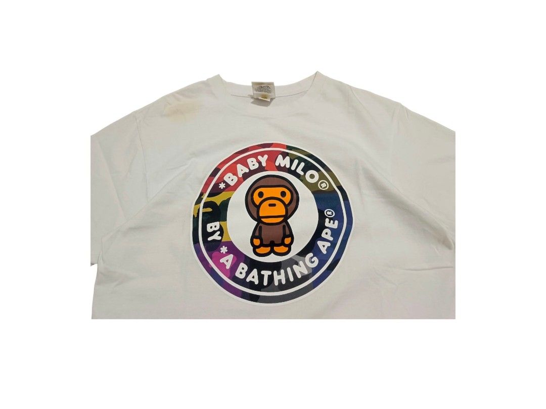 A Bathing Ape Baby Milo Grid Camo (Category: Tshirts & Polo Shirts ) located in Manila. Submitted by southstreethub.ph (Listing ID 1464896862, Image 2). Description: - A Bathing Ape Baby Milo Grid Camo - Size: Medium (tag inside collar) - Dimention: 19.5 Width 27.5 Lenght - Details: Signature ape head logo tag on left sleeve hem, includes woven neck tags - Material: 100% cotton, short sleeves - Condition: Good, with minor yellowing/staining near 