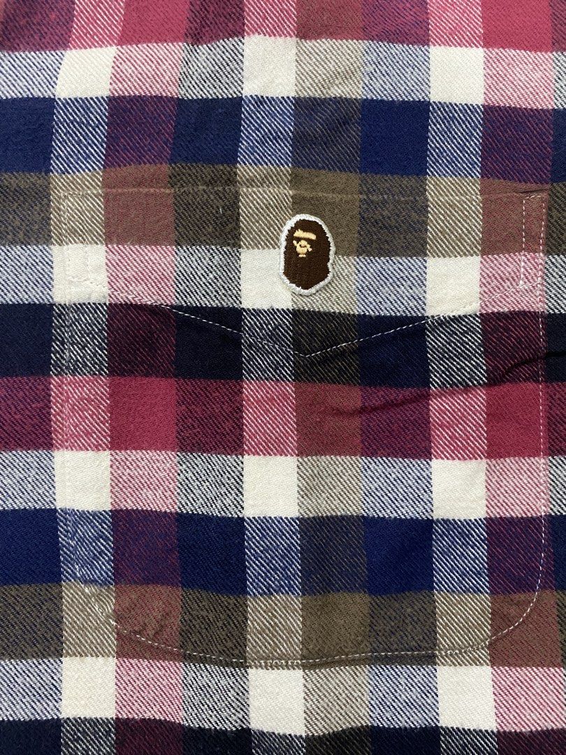 A Bathing Ape (BAPE) (Category: Formal Shirts) located in Cebu City. Submitted by trppydre (Listing ID 1464881199, Image 3). Description: This is a short-sleeve button-down plaid shirt from A Bathing Ape (BAPE) featuring a multi-color check pattern in red, blue, white, and brown with a small ape head logo on the chest pocket..