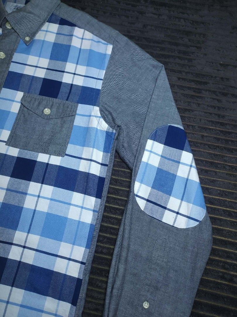A Bathing Ape BAPE Blue Plaid Patchwork Button-Up Shirt (Category: Tshirts & Polo Shirts ) located in Manila. Submitted by norathrifted (Listing ID 1464802043, Image 3). Description: - Brand: A Bathing Ape (BAPE) - Item: Blue plaid patchwork button-up shirt - Size: Medium (M) - Details: Blue/white check pattern with grey chambray sleeves, collar, and dual chest pockets - Unique Features: Plaid elbow patches, button-down collar, and signature BAPE