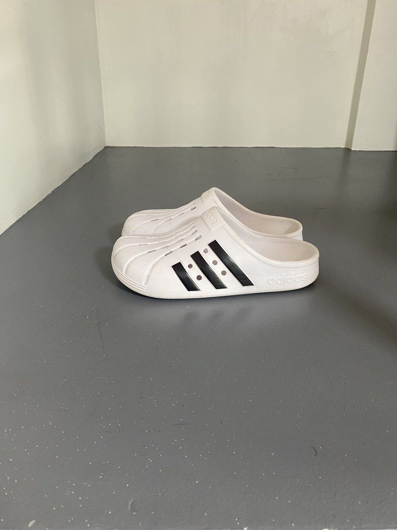 Adidas Adilette Clog (Category: Sneakers) located in Pasig City. Submitted by silentgem-ac4d (Listing ID 1464918512, Image 3). Description: US 6W - Sa adidas store mismo nabili. Got it for P3200 - Brand: Adidas - Style: White slip-on sandals with iconic black side stripes - Design: Perforated toe box with classic shell-toe details - Comfort: Lightweight build with a supportive molded footbed - Condition: Clean, excellent overall condition with mi