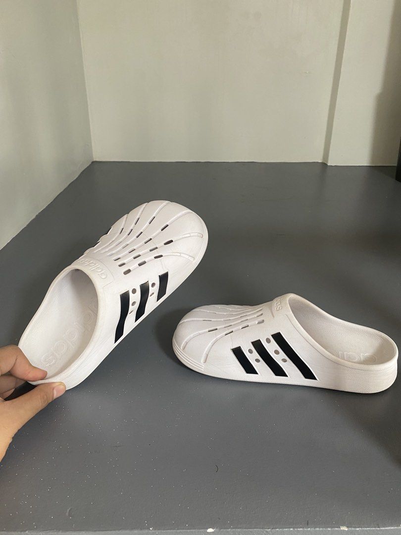 Adidas Adilette Clog (Category: Sneakers) located in Pasig City. Submitted by silentgem-ac4d (Listing ID 1464918512, Image 2). Description: US 6W - Sa adidas store mismo nabili. Got it for P3200 - Brand: Adidas - Style: White slip-on sandals with iconic black side stripes - Design: Perforated toe box with classic shell-toe details - Comfort: Lightweight build with a supportive molded footbed - Condition: Clean, excellent overall condition with mi
