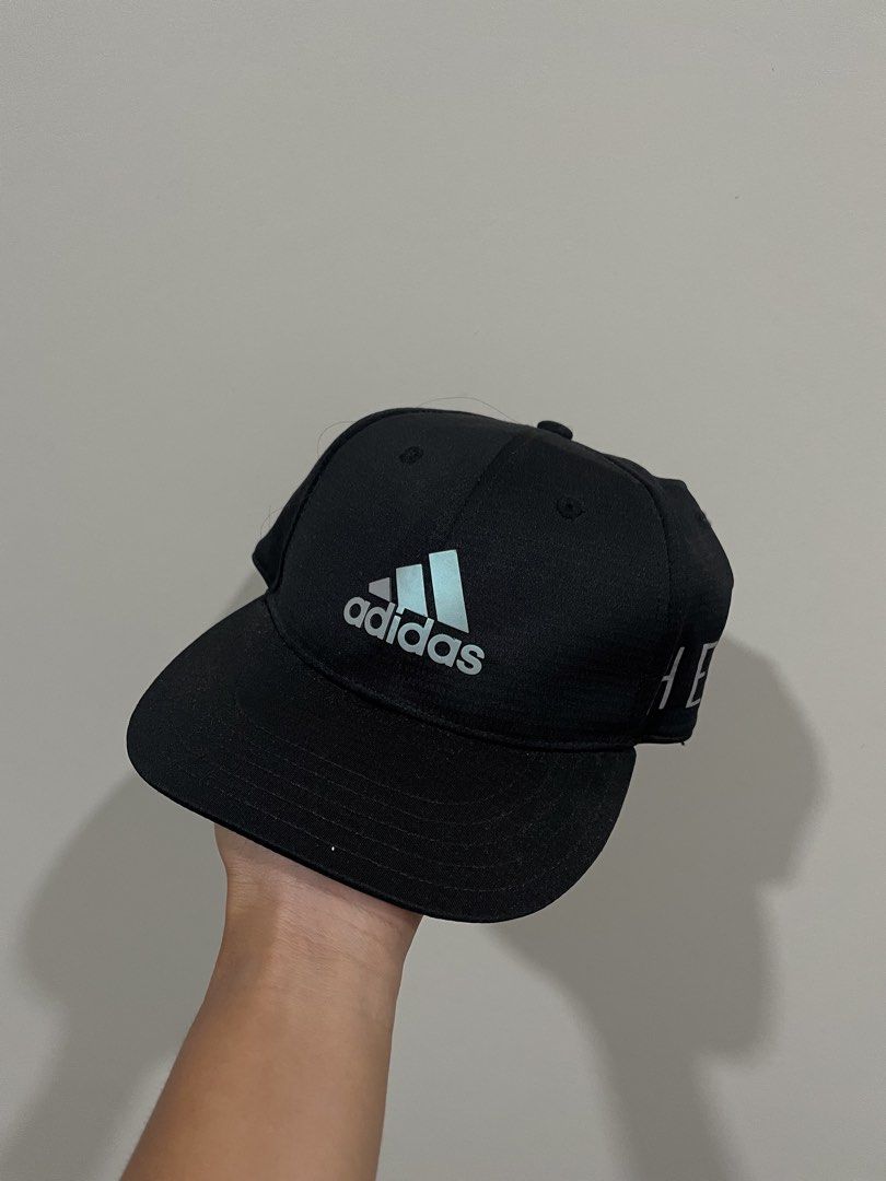 Adidas Black Cap with Silver Logo (Category: Caps & Hats) located in Bacolod City. Submitted by jmcercado (Listing ID 1464964998, Image 1). Description: - Brand: Adidas - Color: Classic black with silver embroidered logo - Style: Flat brim with subtle side lettering on the left panel - Fit: Adjustable strap closure in the back - Condition: Brand new / Excellent - Perfect for everyday casual wear.