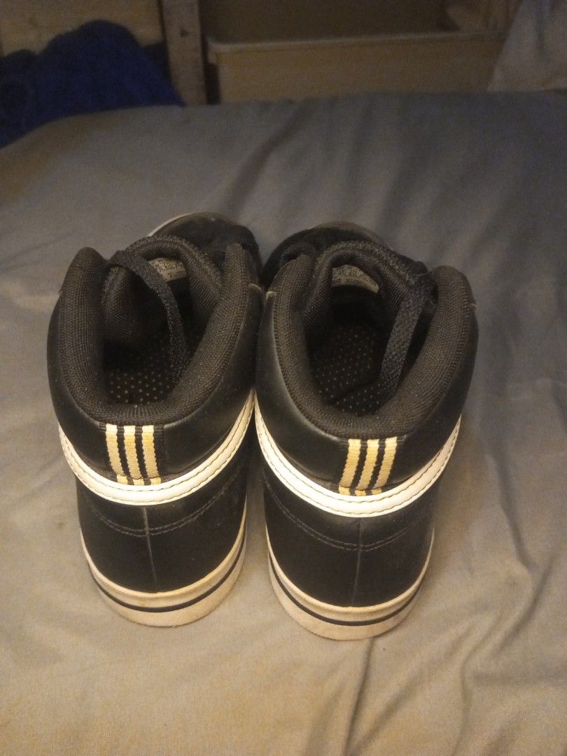 Adidas Black High Top Sneakers (Category: Casual Shoes) located in Manila. Submitted by ikomic20 (Listing ID 1464851910, Image 3). Description: - Brand: Adidas - Style: High-top sneakers - Color: Black with classic white stripes and black laces - Features: Padded ankle collar, three-stripes detail on back heel tab, size tag visible inside tongue - Condition: White rubber soles show light dirt from normal wear - Ready for a new home!.