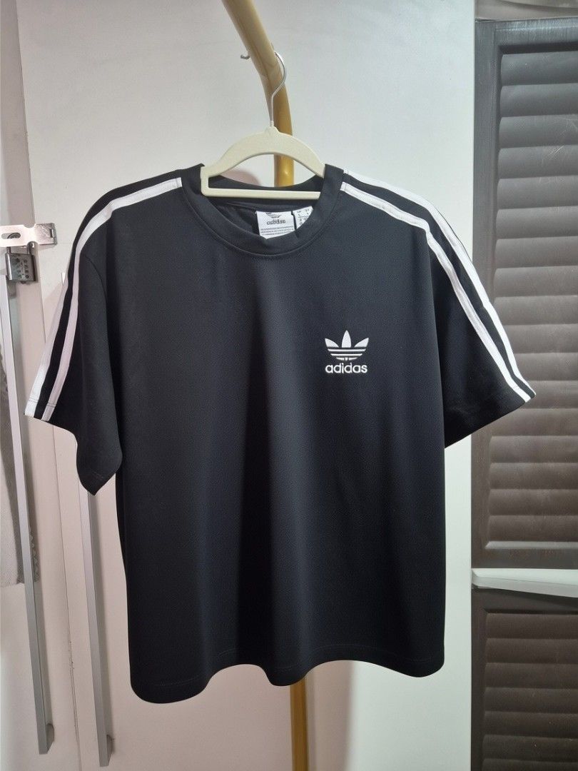 Adidas boxy T-shirts - Multiple Colors Available (Category: Shirts) located in Taguig. Submitted by chloe_clothingco. (Listing ID 1464389431, Image 2). Description: - Adidas Boxy T-shirts sizes Med -2XL - Available colors: Light Green, Black, Orange, Peach, White, Green, Purple - Features the iconic Adidas logo on each shirt - Ideal for casual everyday wear - Mix and match your favorite colors!.