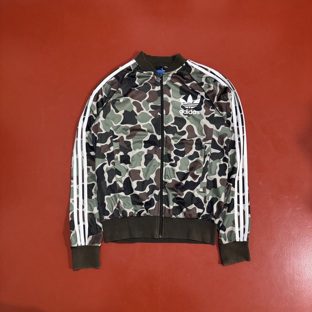 ADIDAS CAMOUFLAGE TRACK JACKET (Category: Coats, Jackets and Outerwear) located in Pasig City. Submitted by buzzthrifty (Listing ID 1464891927, Image 2). Description: SIZE S-M MEN M-L WOMEN 20x26 LINTS SA LOWER PART LAST PIC .
