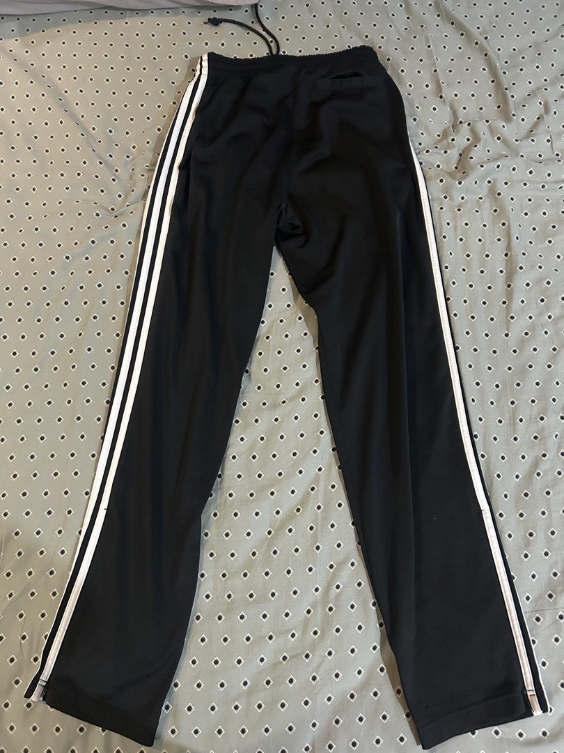 Adidas Firebird Trackpants (Category: Joggers) located in Makati City. Submitted by racarbon (Listing ID 1464826033, Image 2). Description: - Brand: Adidas Originals - Color: Black with white three-stripe side taping and trefoil logo - Size: S (fits true to size) - Material: Made with sustainable Parley Ocean Plastic - Features: Elastic adjustable drawstring waistband, side zipper pockets, and ankle zippers at the hems - Condition: Normal wear wi