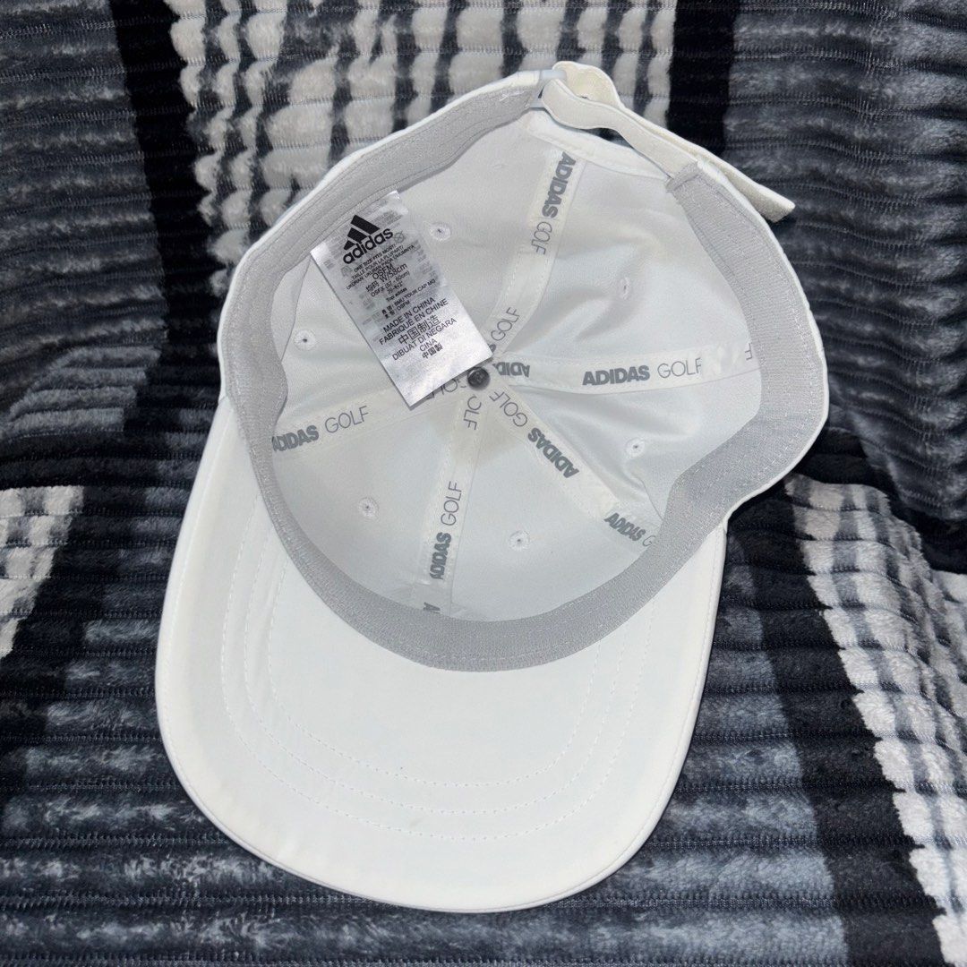 Adidas Golf White Cap OSFM Adjustable (Category: Caps & Hats) located in Iligan City. Submitted by 9200rsnl (Listing ID 1464797994, Image 3). Description: - Brand: Adidas - Color: White with metallic silver logo - Size: OSFM (fits head circumference 57 to 60 cm) - Fit: Adjustable strap in the back - Features: Grey sweatband and branded inside seam taping - Condition: Clean, excellent, and ready to wear - Origin: Made in China - Perfect for: Golf 